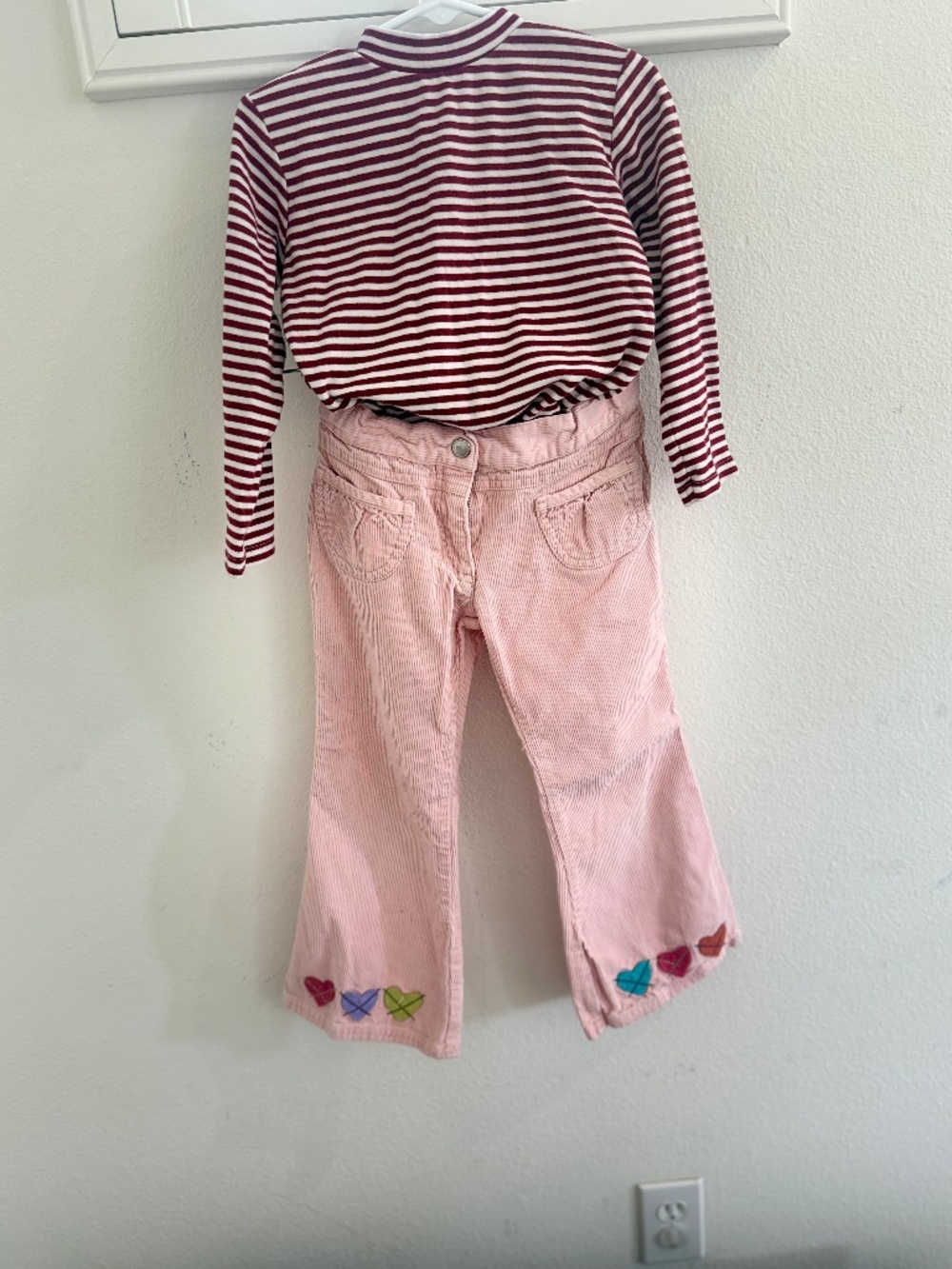 Pink corduroy trousers and stripy mock turtleneck